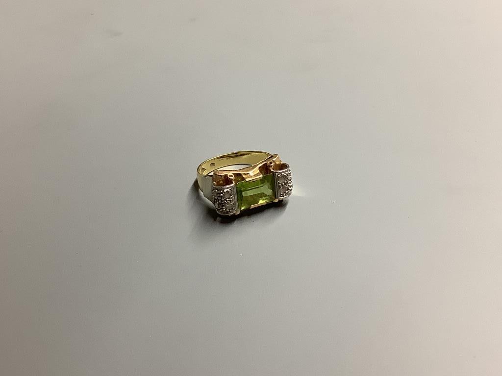 A 1950's? 750 yellow metal, peridot and diamond set dress ring, size O, gross 6.9 grams.